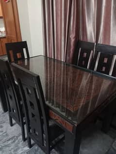 A dinning table with six chairs