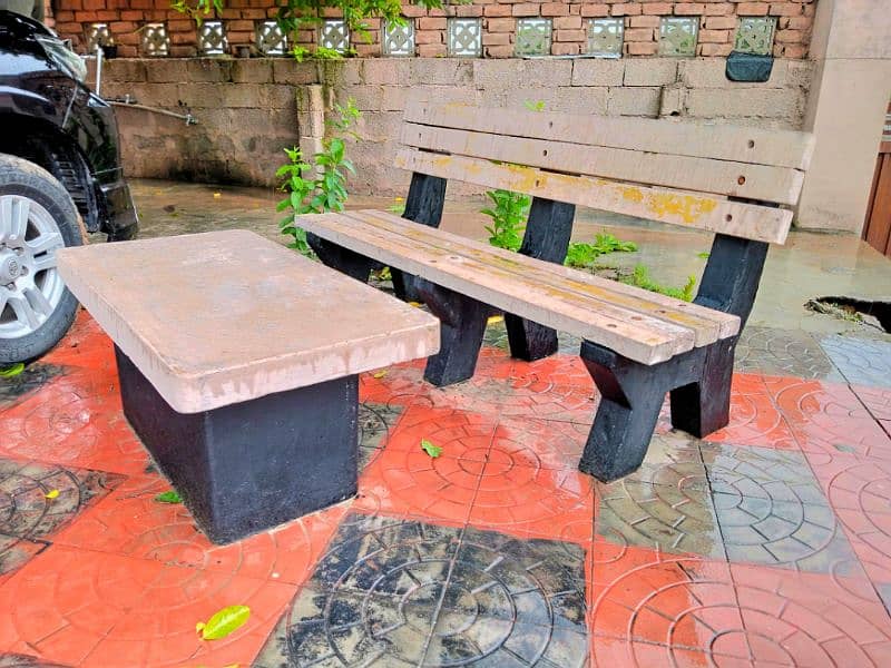 Outdoor concrete bench with table. 0