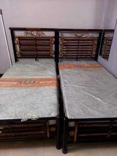 Pair of 2 single beds just like new, covered mattresses totally unused