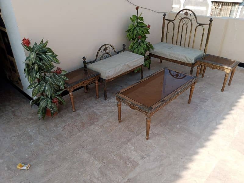 iron sofa set with tables and plants 0