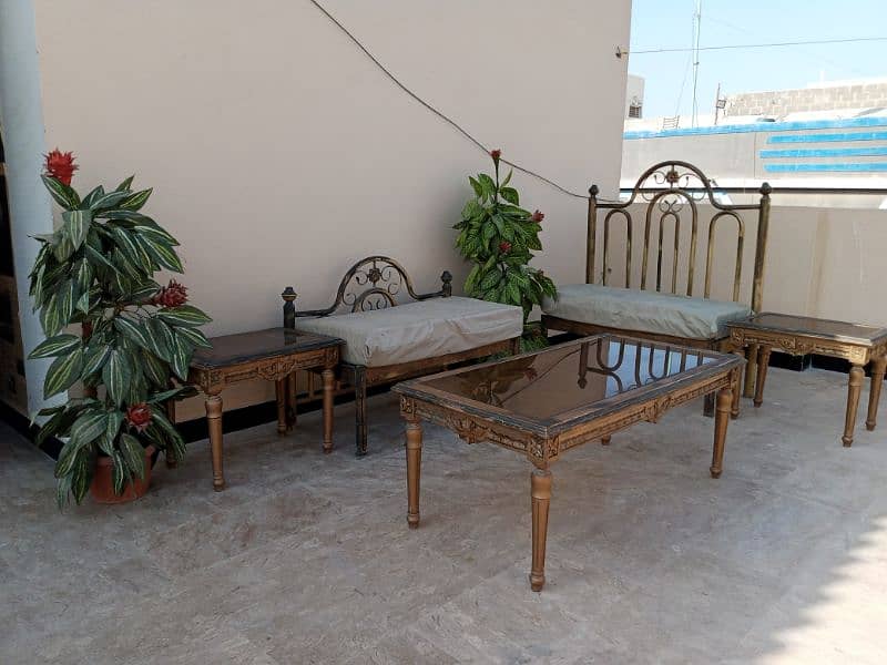 iron sofa set with tables and plants 1