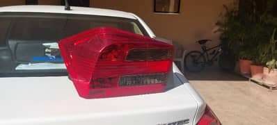 Original Honda City rear left light - slightly cracked.