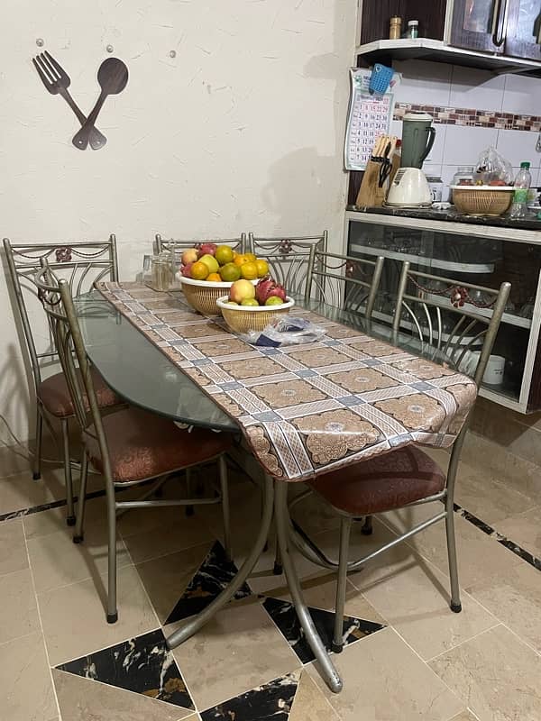 iron dinning table ,  glass top , with 6 chairs. 1