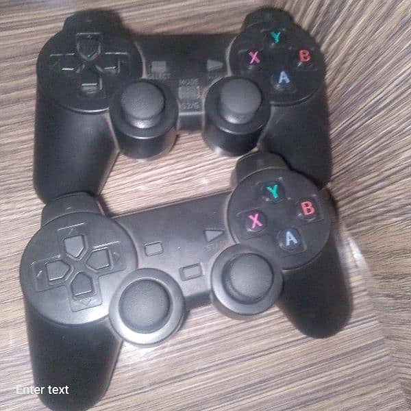 two controllers with a game stick 0