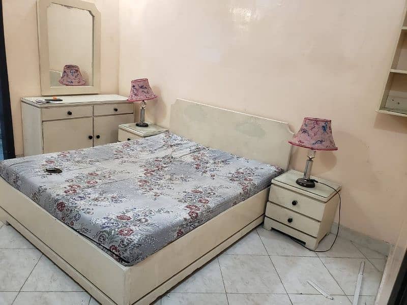 Bed with side tables. . dressing table. . cupboard 0