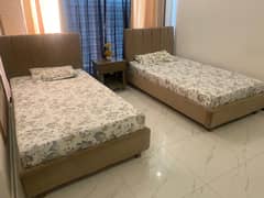 2 Single Beds (6.5’ by 4’) with Mattresses (Orthotic) + 1 Side Table