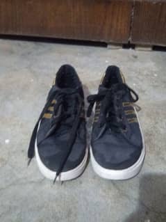 black sneaker with Golden design