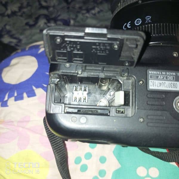 camera. stick. flash. charger. two batteries 4