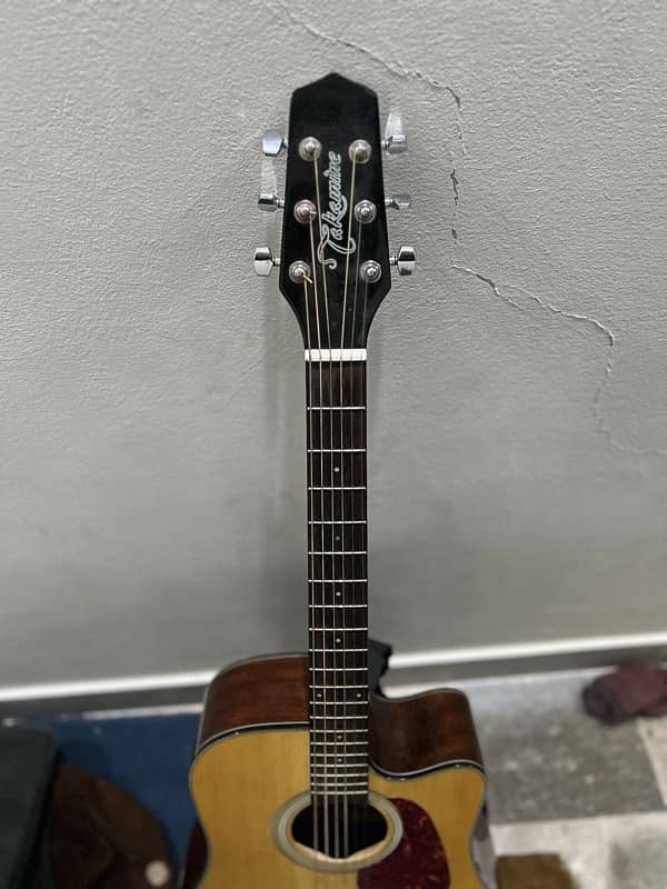 takamine branded guitar with capo picks and bag 1