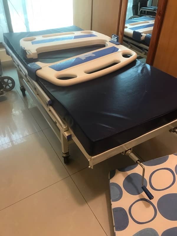 articulated hospital bed with mattress and inflatable air mattress . 6