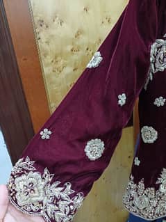 plum velever lehnga with white golden embroidery