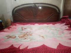 Double bed with new mattress and wooden sheet