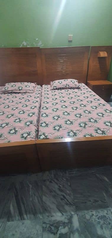 2 single beds along with medicated mattress with one side table 4