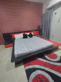 Wooden black an red color bed