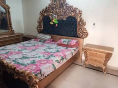 wooden bed and dressing table