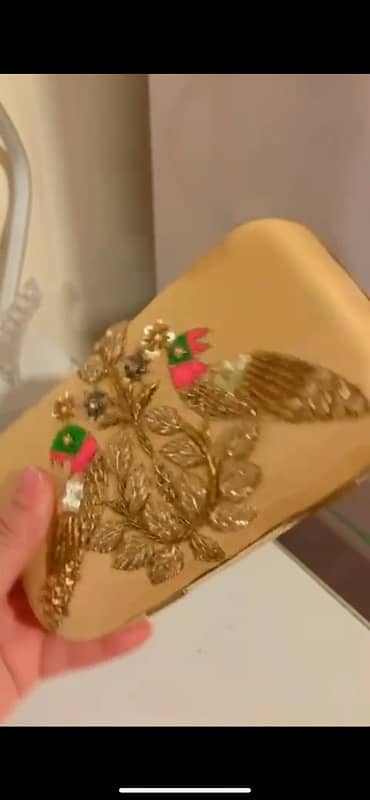 Stylish golden clutch with embellishment 1