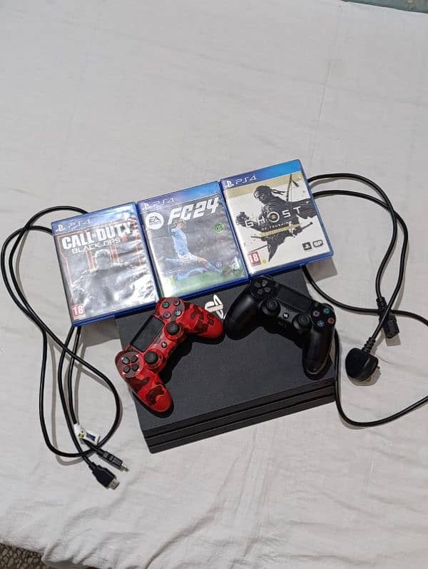 PS4 pro with 2 controllers and 4 games 0