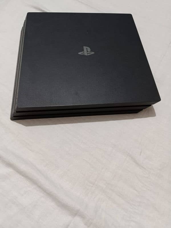 PS4 pro with 2 controllers and 4 games 4