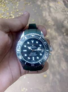 Rolex(oyesters perpetual) with black dial (green straps)