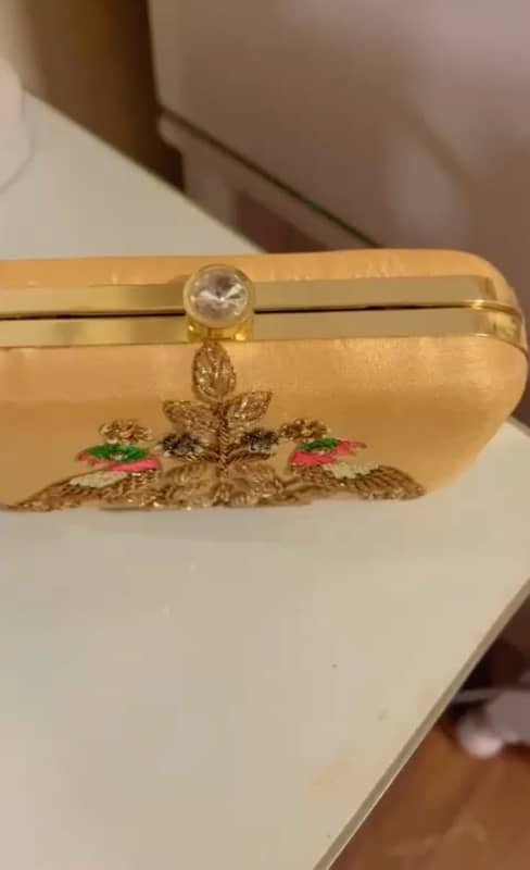 Stylish golden clutch with embellishment 2