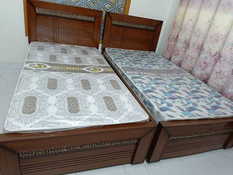 2 single bed with mattresses 1