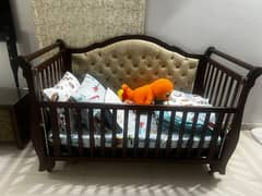 Title: Elegant Wooden Baby Crib with Upholstered Headboard