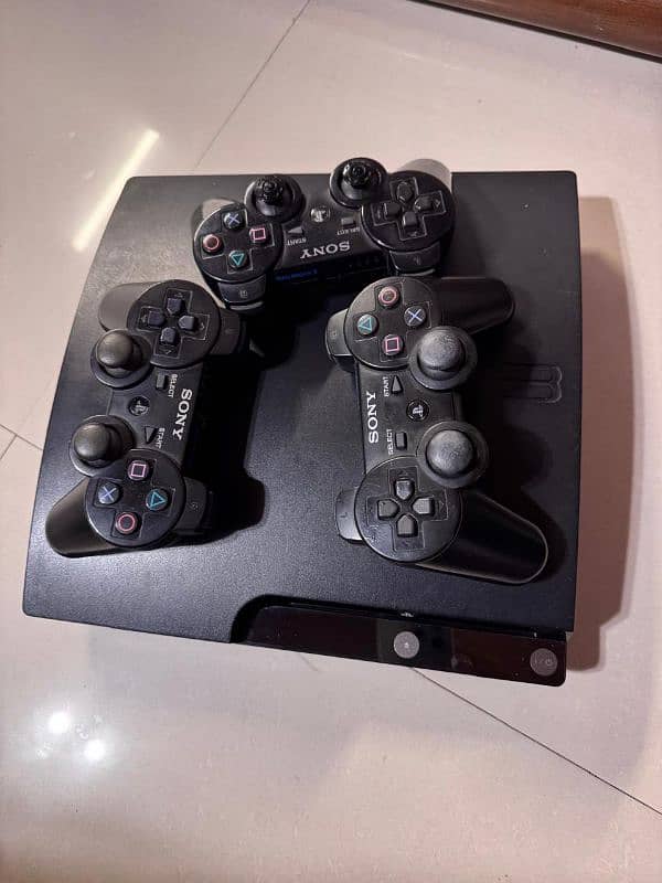 ps3 console with 3 controllers 0