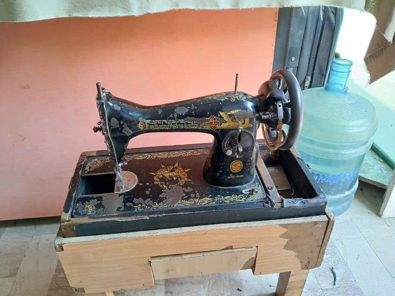 I am selling SINGER sewing machine with stand 2