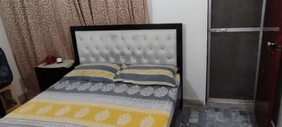 bed with mattress and single side table