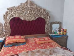 bed with side table and mirror with dressing table