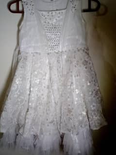 Fancy dress for girl in white colour in used with diamond nets button