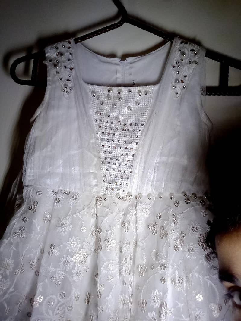 Fancy dress for girl in white colour in used with diamond nets button 1