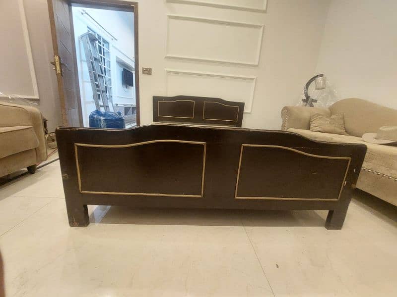 Wooden bed with a side table and dressing table not to old. 2