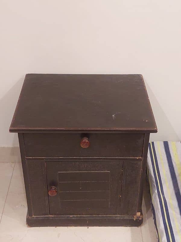 Wooden bed with a side table and dressing table not to old. 5