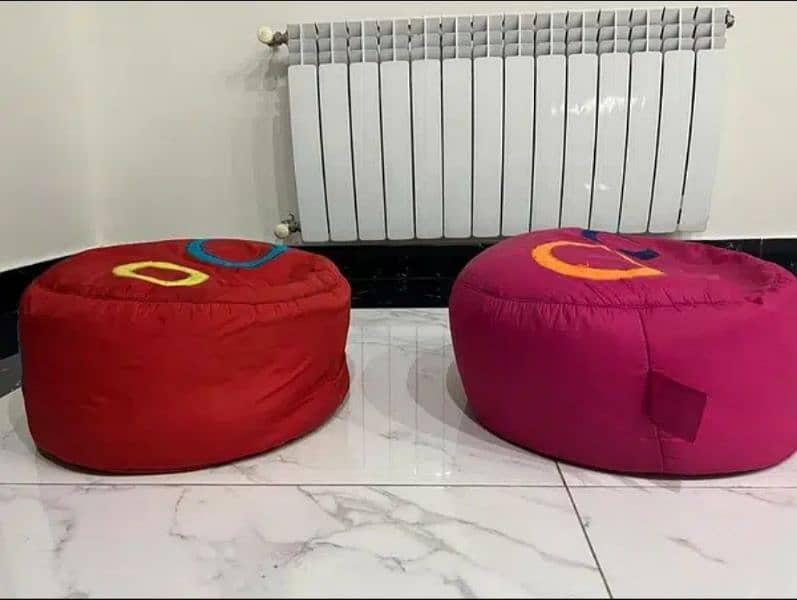 2 stools with table. 6 kids cushions. 2 bean bags 10