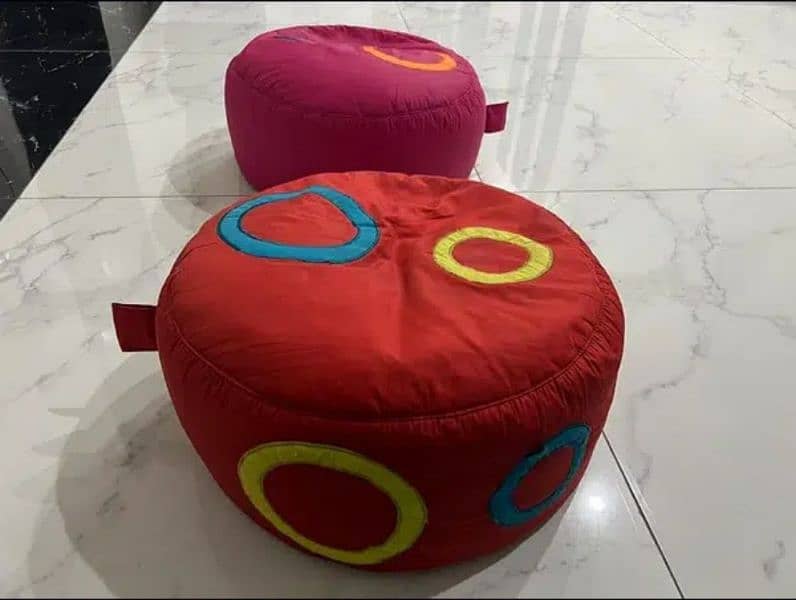 2 stools with table. 6 kids cushions. 2 bean bags 11