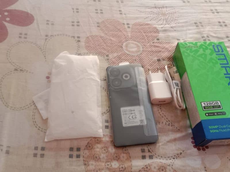 iam selling my Infinix smart 8 pro with box and charger and case 12