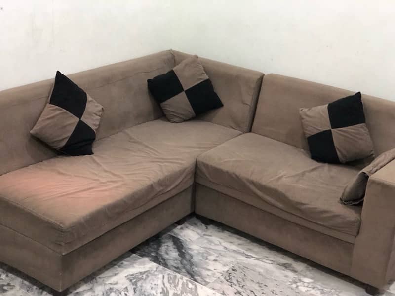 L-shaped sofa with cushions 1