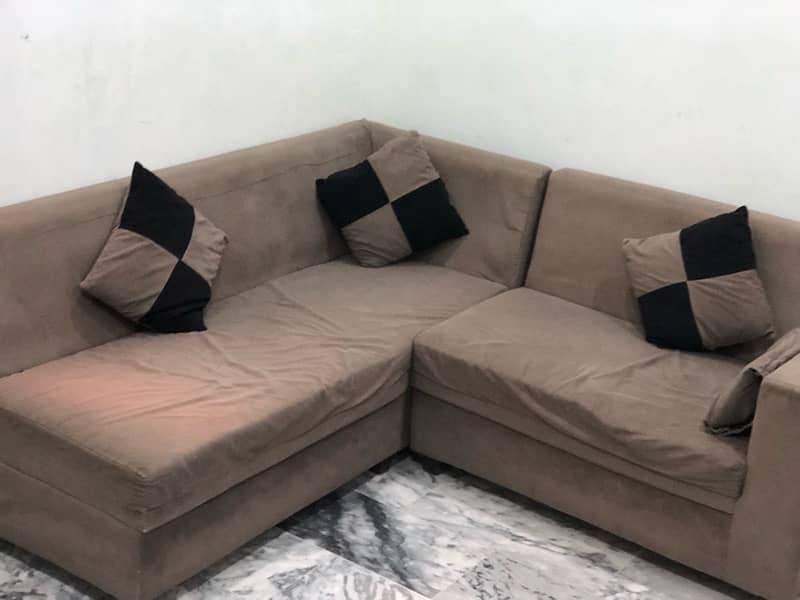 L-shaped sofa with cushions 2