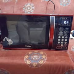 HAIRE MICROWAVE ONLY SLIGHTLY USED WITH BAKING AND GRILL FUNCTION