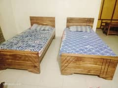 2 wooden single beds