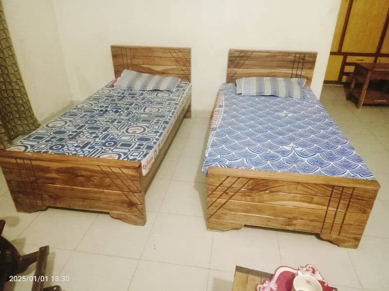 2 wooden single beds 1