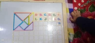 white and black board with magnetic blocks of alphabets