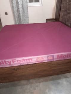 King Size wooden bed with 2 side tables and a sofa seat