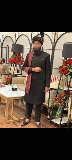 Groom sherwani in black with matching khussa and kulla