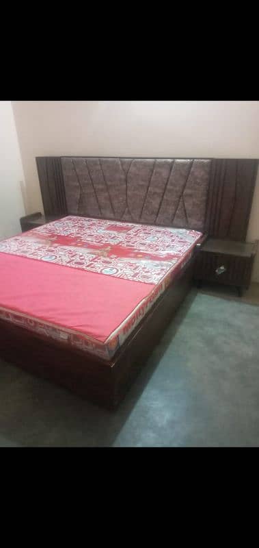 King Size wooden bed with 2 side tables and a sofa seat 1