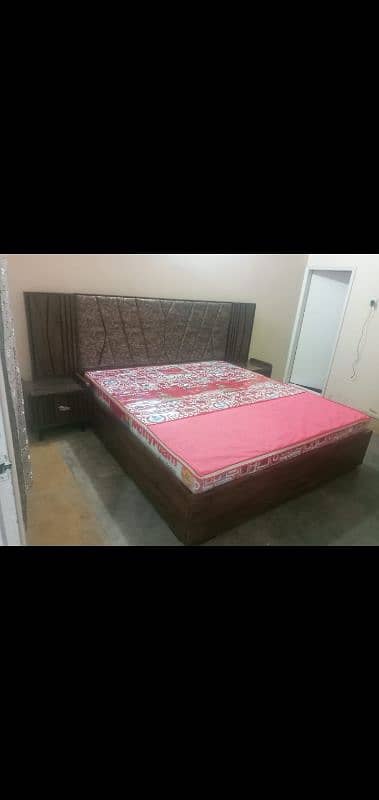 King Size wooden bed with 2 side tables and a sofa seat 2