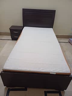 single bed with side table and mattress