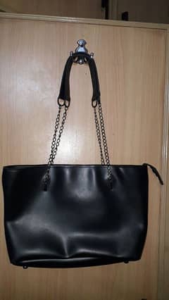 Big black handbag with stylish chains