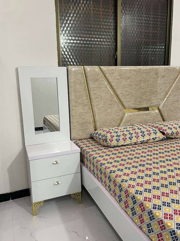 White bed set with side tables and vanity. 0